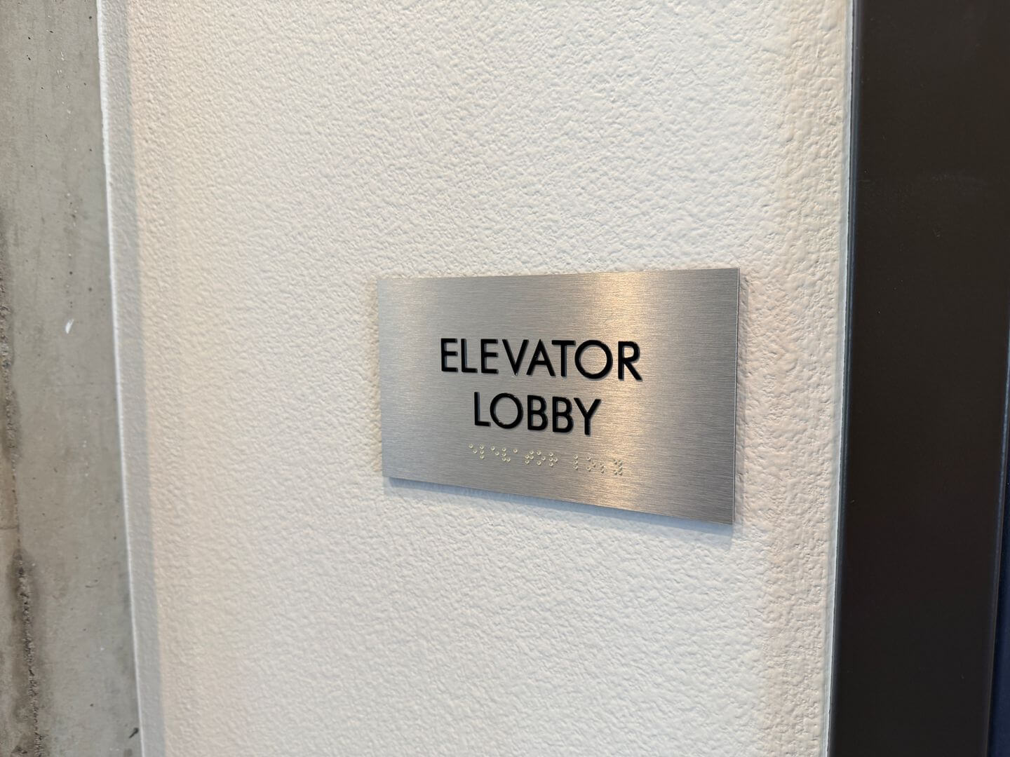 Elevator lobby signage with braille lettering