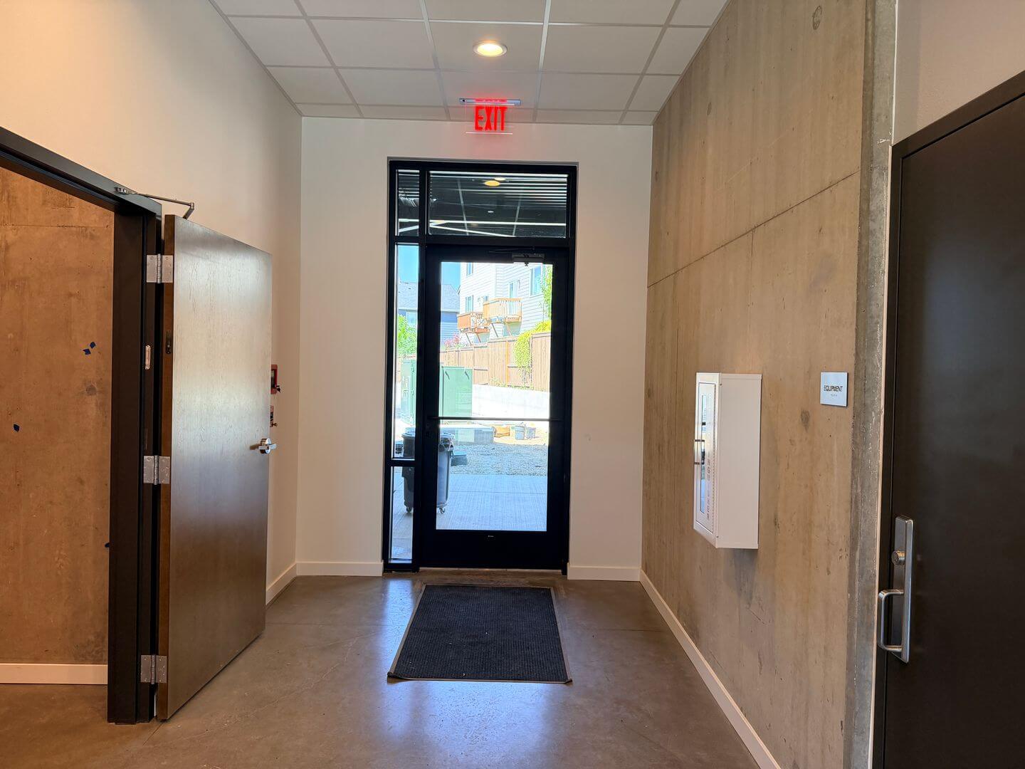 Secure building entry and exit corridor with equipment room