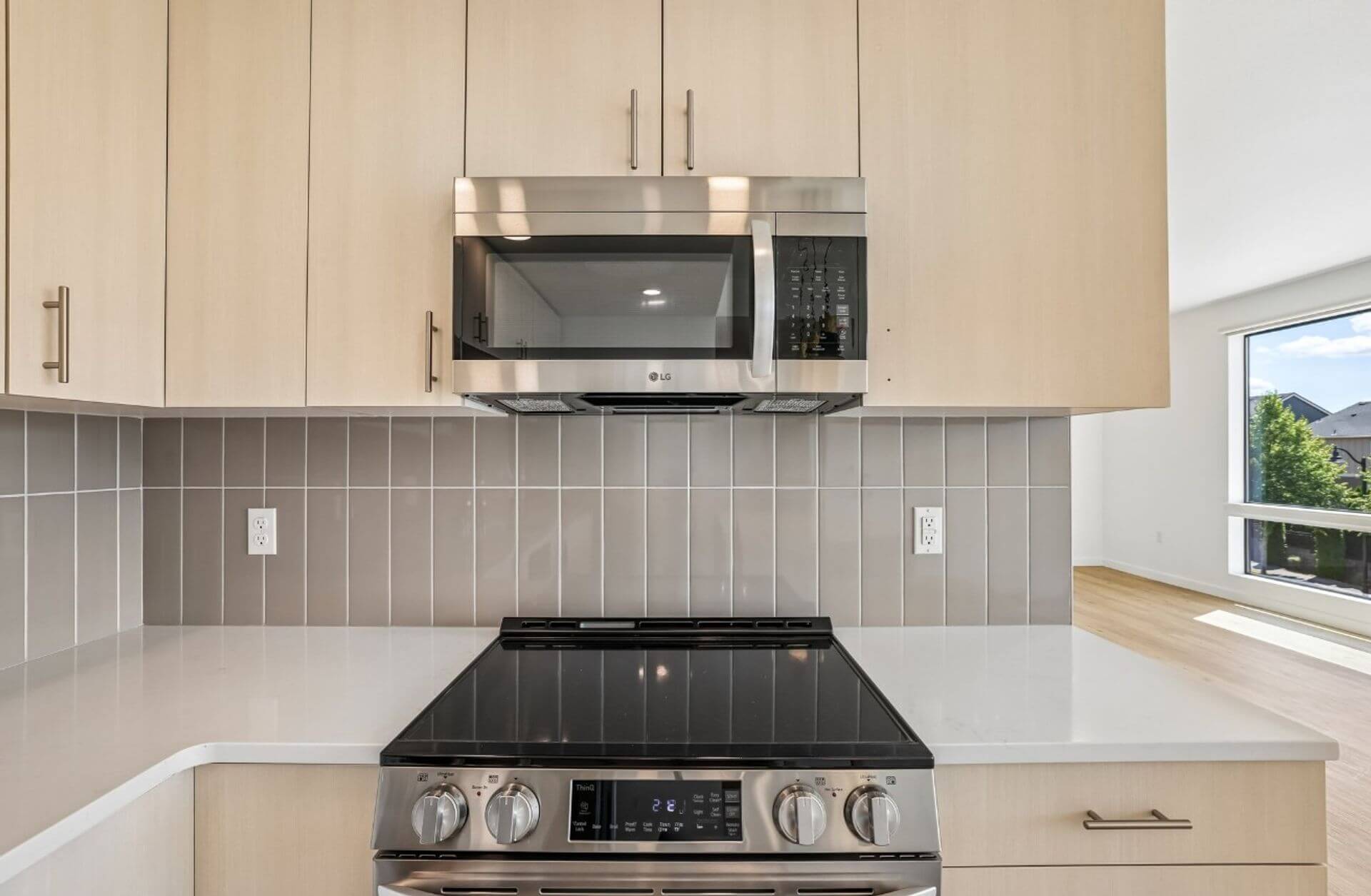 Stainless steel range and microwave with tile backsplash