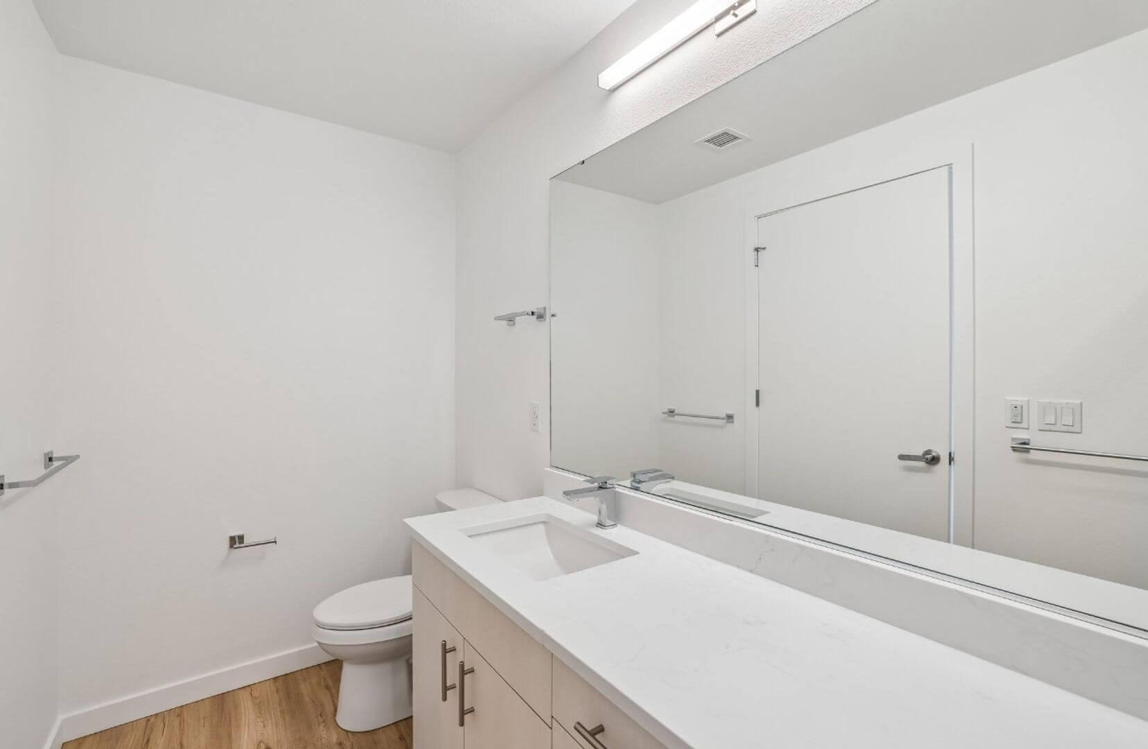 Bathroom vanity with quartz counter and large mirror