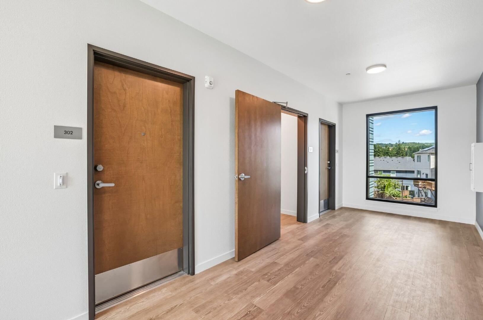 Private residence entry door for unit 302 with interior room beyond