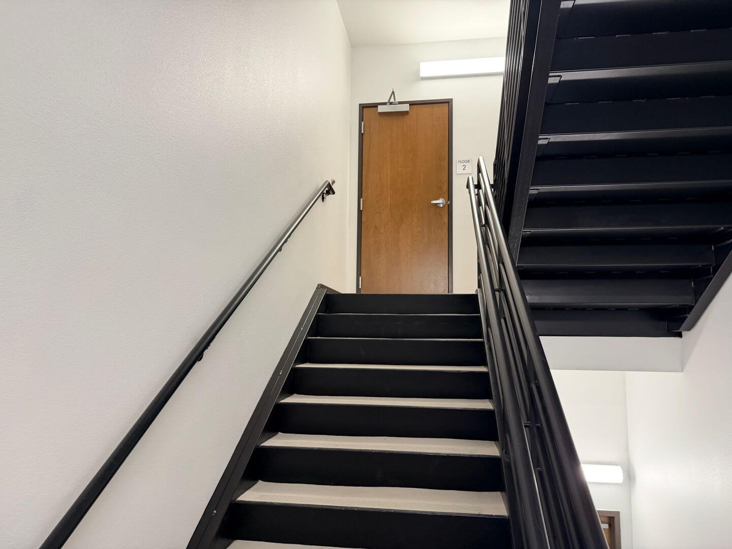 Building stairwell with handrail leading to the second floor